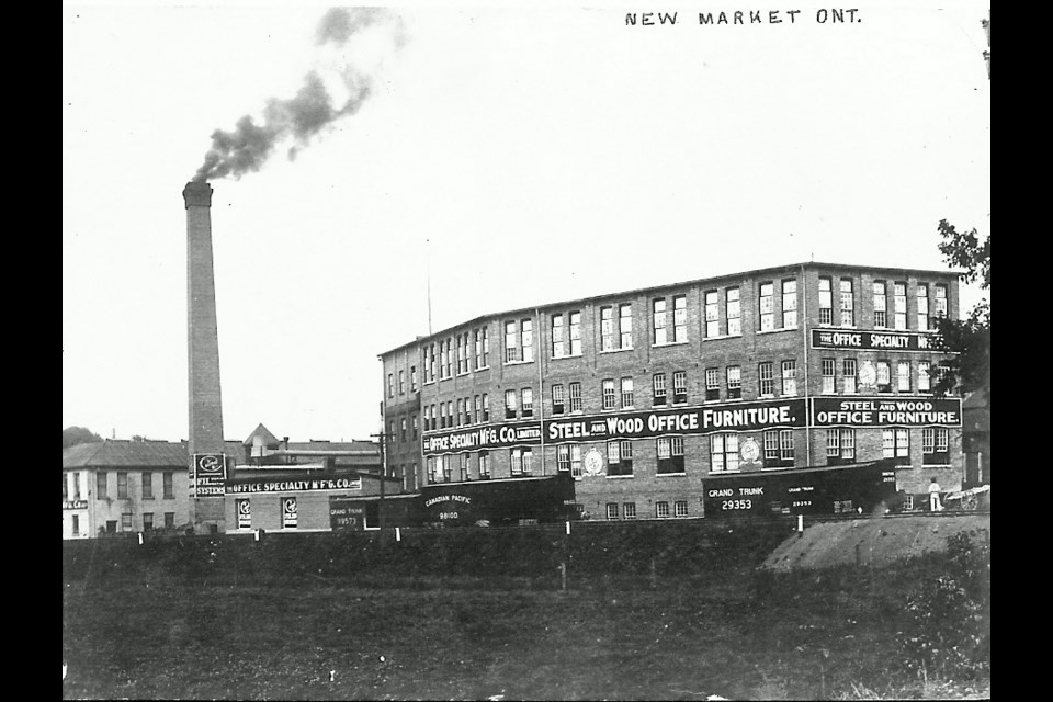 The factory with Canadian Pacific and Grand Trunk train cars at the loading dock.